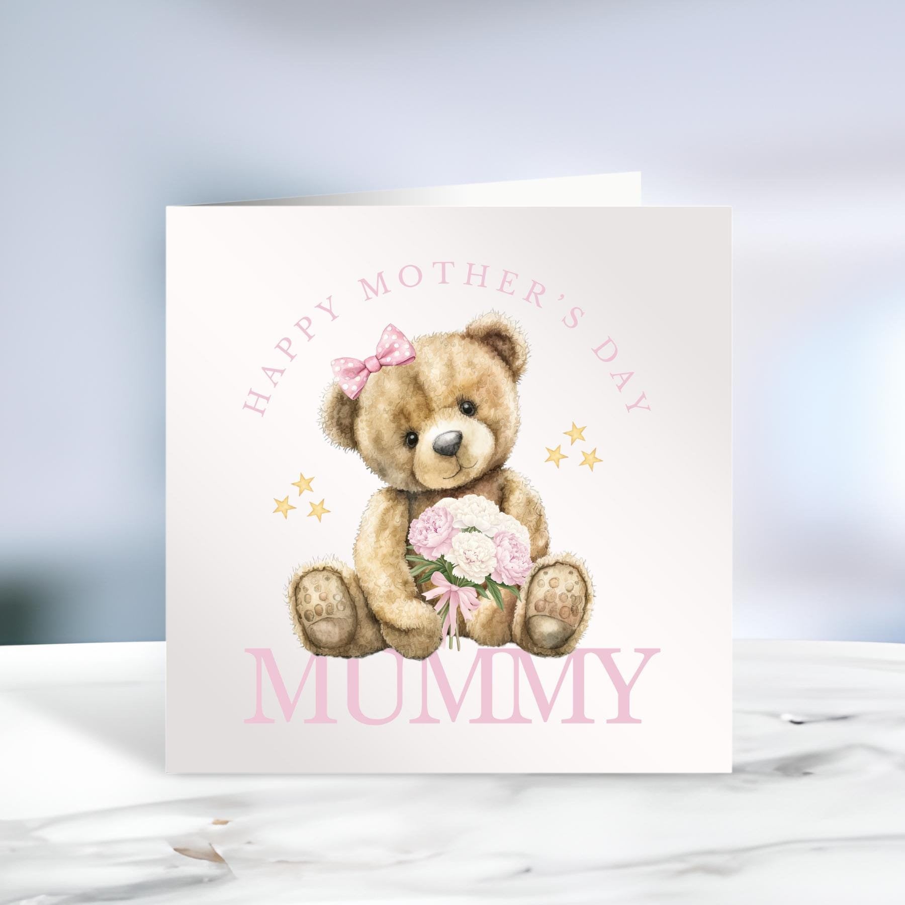Mother’s Day Card featuring the text ‘Happy Mother’s Day Mummy’ in pink writing and a teddy bear holding a bouquet of pink flowers. Other images show the text in blue, and different name variations ie Mammy, Granny.